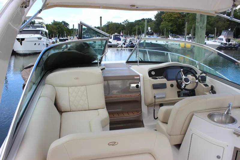  Yacht Photos Pics 2014 Regal 32 Express boat interior with helm, seating, and marina view.