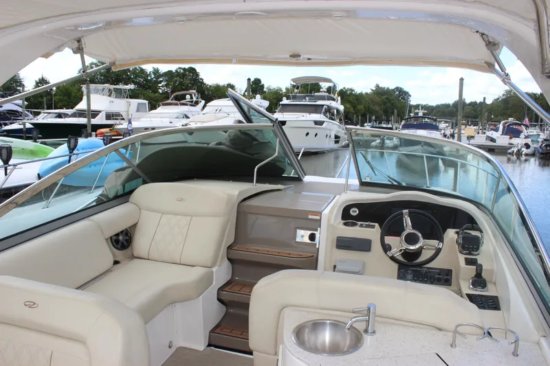  Yacht Photos Pics 2014 Regal 32 Express boat interior with helm, seating, and marina view.