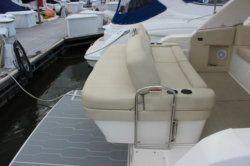  Yacht Photos Pics 2014 Regal 32 Express boat with beige seating and swim platform at marina.