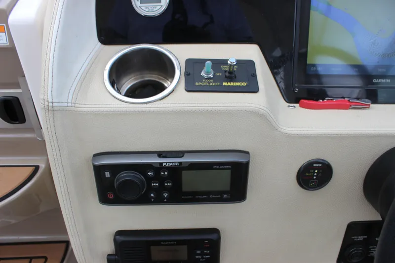  Yacht Photos Pics 2014 Regal 32 Express dashboard with Garmin display, Fusion audio system, and Marinco spotlight controls.