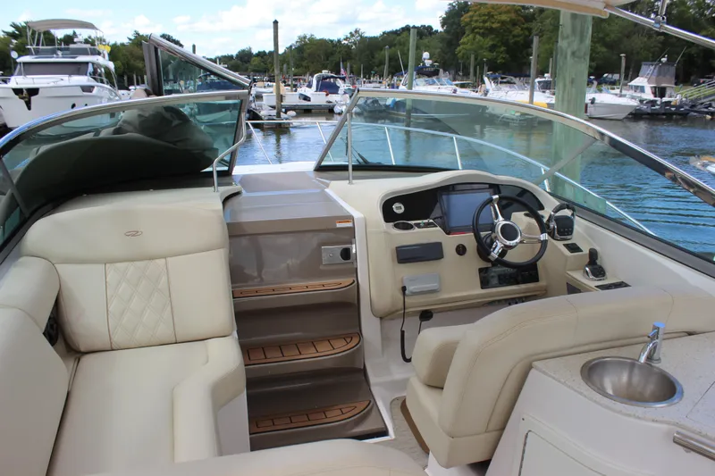  Yacht Photos Pics 2014 Regal 32 Express boat interior with helm, seating, and marina view.