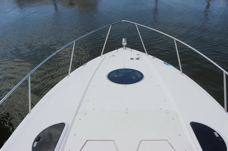  Yacht Photos Pics Bow view of 2014 Regal 32 Express boat on calm water.