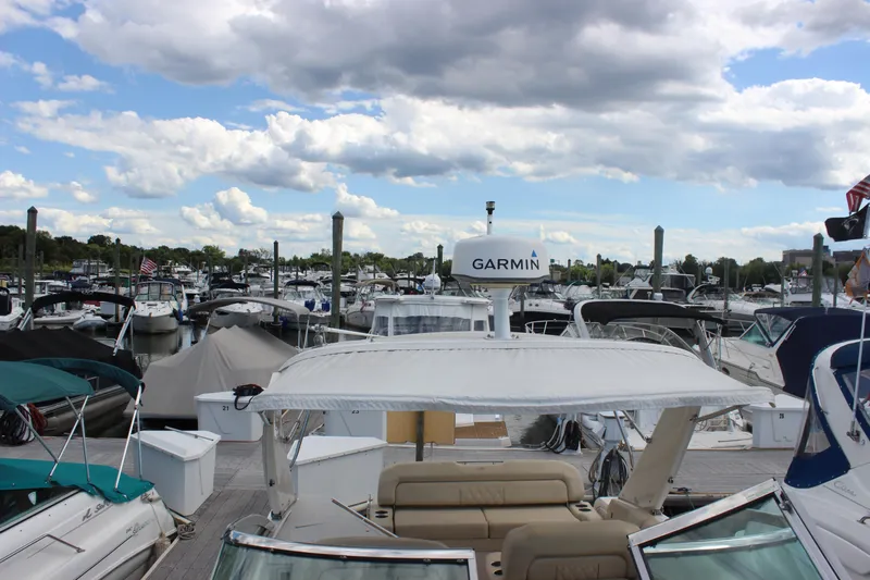  Yacht Photos Pics Marina with 2014 Regal 32 Express boat, featuring Garmin equipment, under a partly cloudy sky.