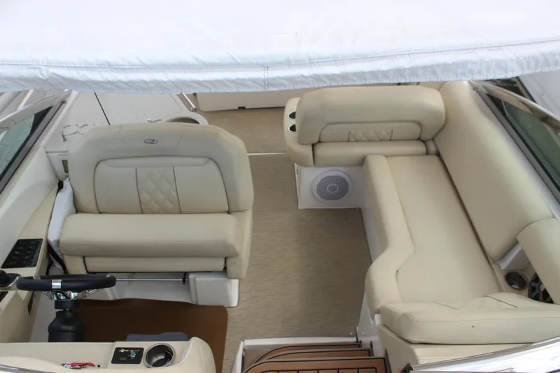  Yacht Photos Pics 2014 Regal 32 Express boat interior with beige seating and steering area.