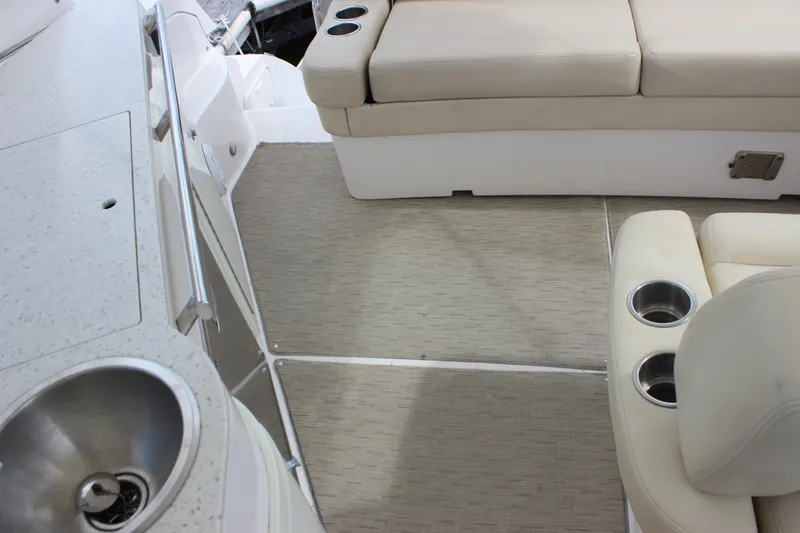  Yacht Photos Pics 2014 Regal 32 Express boat interior with beige seating and cup holders.