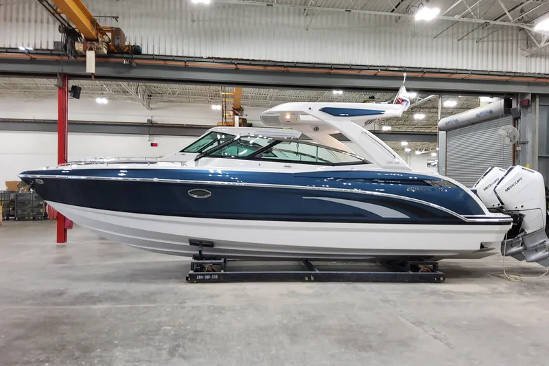  Yacht Photos Pics 2026 Formula 330 Crossover Bowrider OB in a showroom, featuring sleek blue and white design.