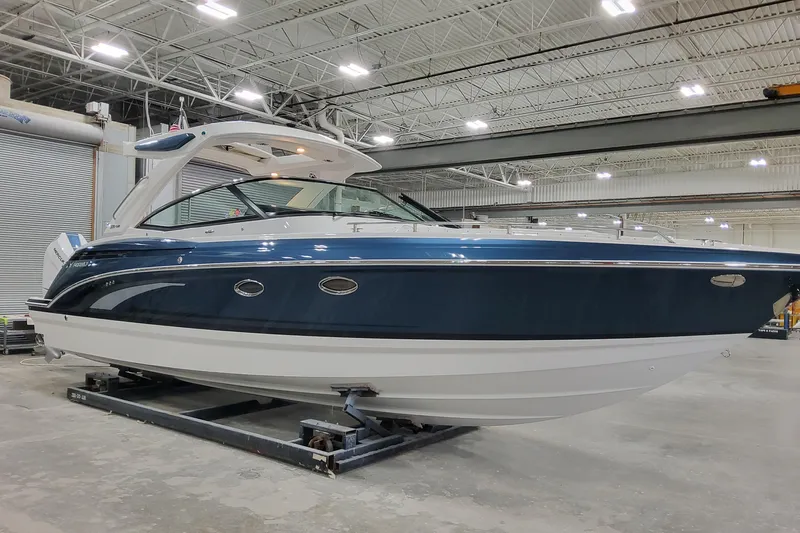  Yacht Photos Pics 2026 Formula 330 Crossover Bowrider OB in a showroom, showcasing sleek design and modern features.