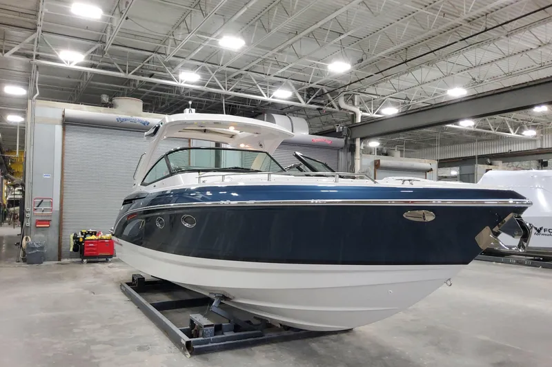  Yacht Photos Pics 2026 Formula 330 Crossover Bowrider OB in a showroom, showcasing sleek design and modern features.