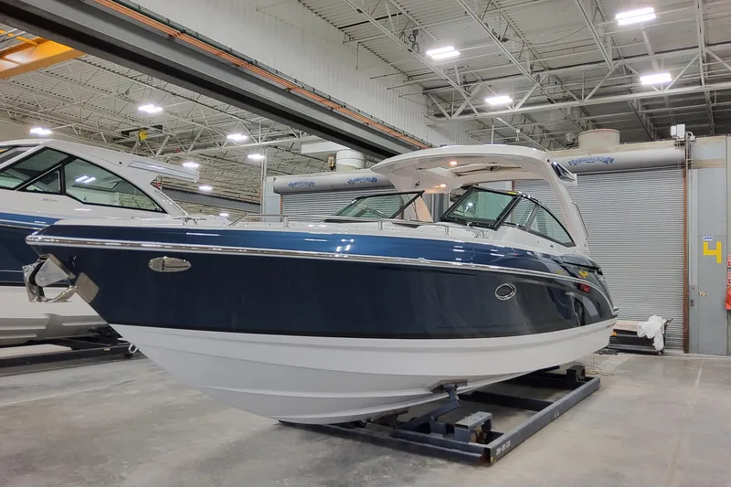  Yacht Photos Pics 2026 Formula 330 Crossover Bowrider OB in a showroom, showcasing sleek design and modern features.