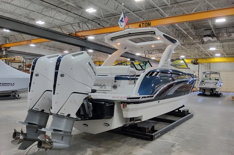  Yacht Photos Pics 2026 Formula 330 Crossover Bowrider OB in a warehouse, featuring dual Mercury outboard engines.