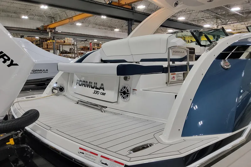  Yacht Photos Pics 2026 Formula 330 Crossover Bowrider OB in a showroom, showcasing sleek design and luxury features.
