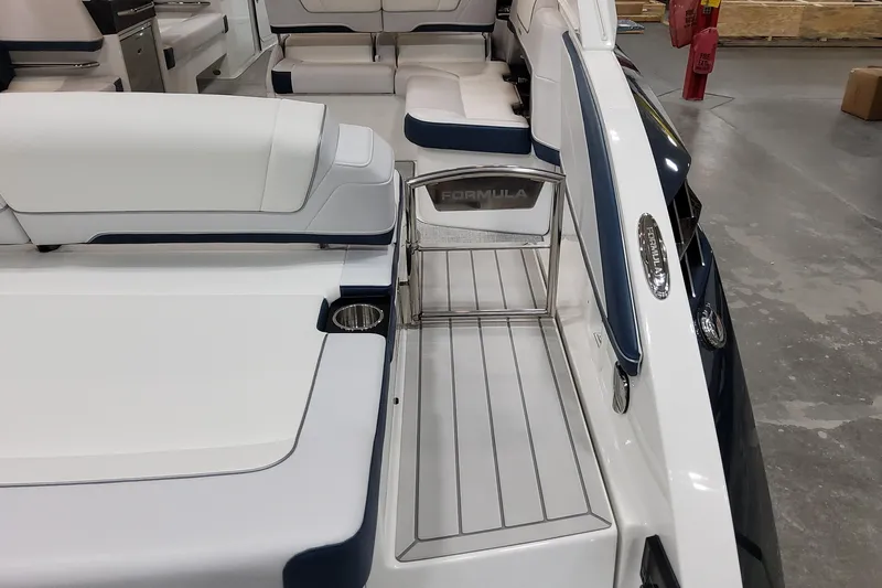  Yacht Photos Pics 2026 Formula 330 Crossover Bowrider OB interior with white seating and stainless steel accents.