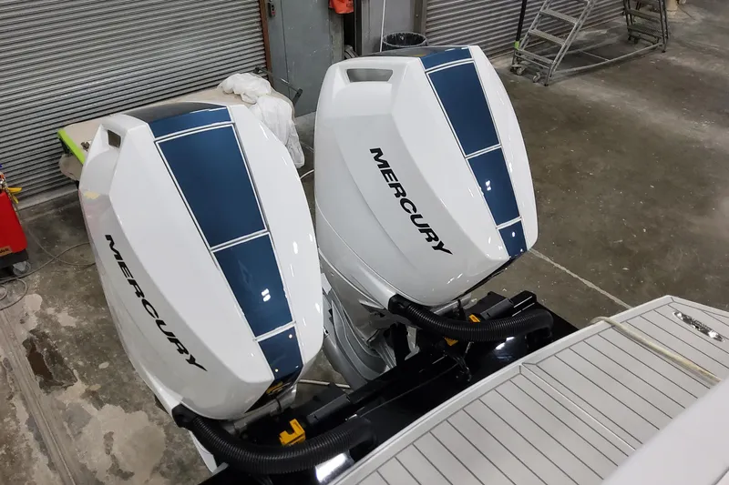  Yacht Photos Pics 2026 Formula 330 Crossover Bowrider OB with dual Mercury outboard engines in a workshop.
