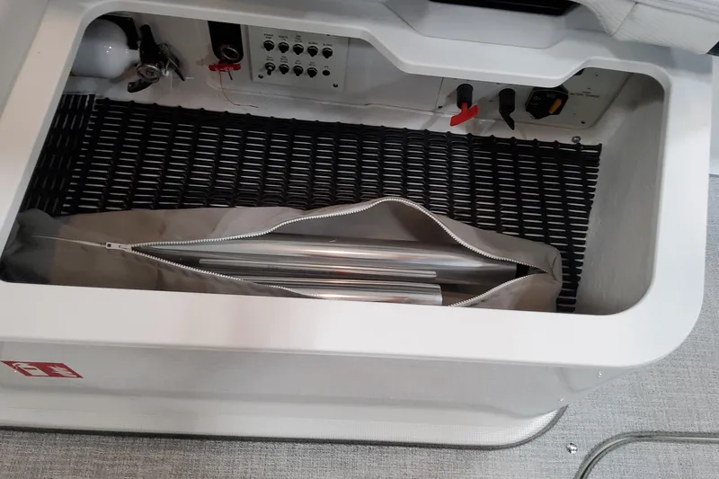  Yacht Photos Pics Storage compartment in 2026 Formula 330 Crossover Bowrider OB with equipment and controls.