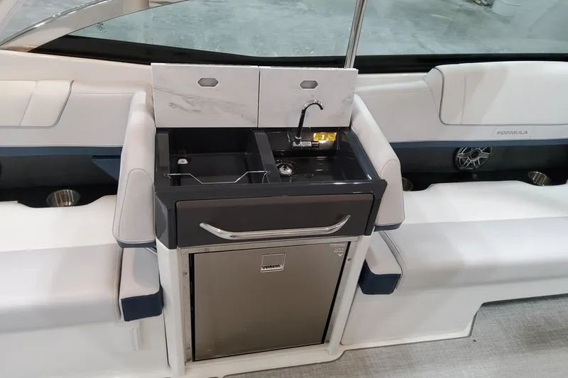  Yacht Photos Pics 2026 Formula 330 Crossover Bowrider OB interior with sink and seating area.