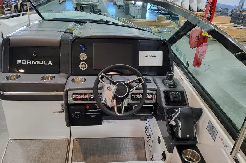  Yacht Photos Pics 2026 Formula 330 Crossover Bowrider OB helm with steering wheel and control panel.