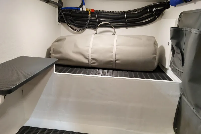  Yacht Photos Pics Storage compartment in 2026 Formula 330 Crossover Bowrider OB with a rolled-up cover.