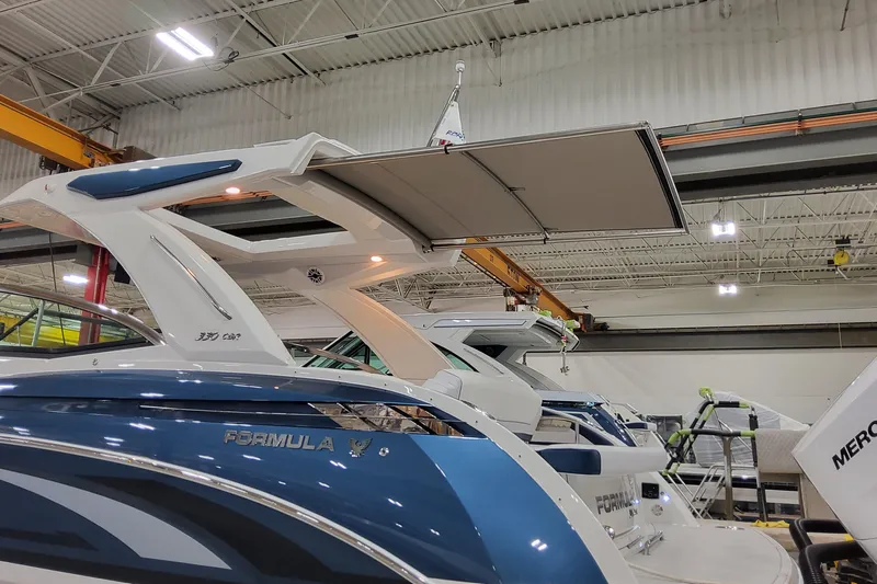  Yacht Photos Pics 2026 Formula 330 Crossover Bowrider OB in a showroom, showcasing sleek design and modern features.