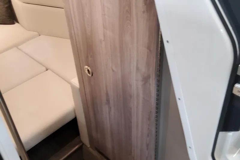  Yacht Photos Pics Interior cabin of 2026 Formula 330 Crossover Bowrider OB with wooden door and white seating.