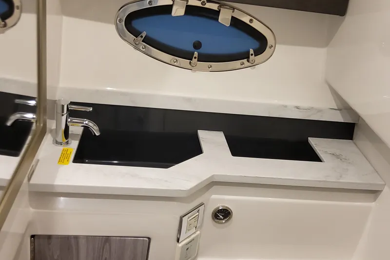  Yacht Photos Pics 2026 Formula 330 Crossover Bowrider OB interior sink with modern design and porthole window.