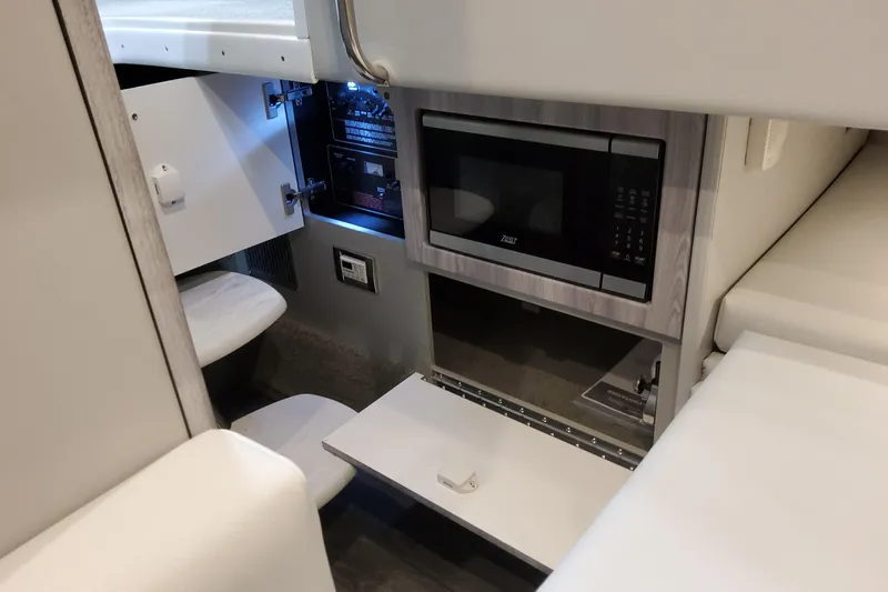  Yacht Photos Pics Interior of 2026 Formula 330 Crossover Bowrider OB with microwave and storage compartments.