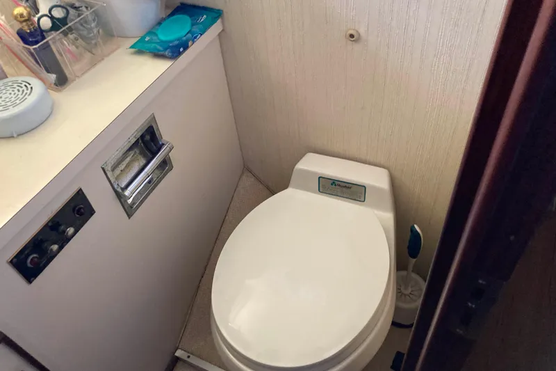 Golden Olive Yacht Photos Pics 1985 Hatteras Sportfish bathroom with toilet and countertop essentials.