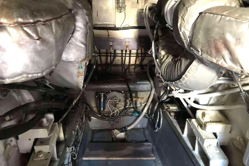 Golden Olive Yacht Photos Pics Engine room of a 1985 Hatteras Sportfish boat, showcasing mechanical components and wiring.