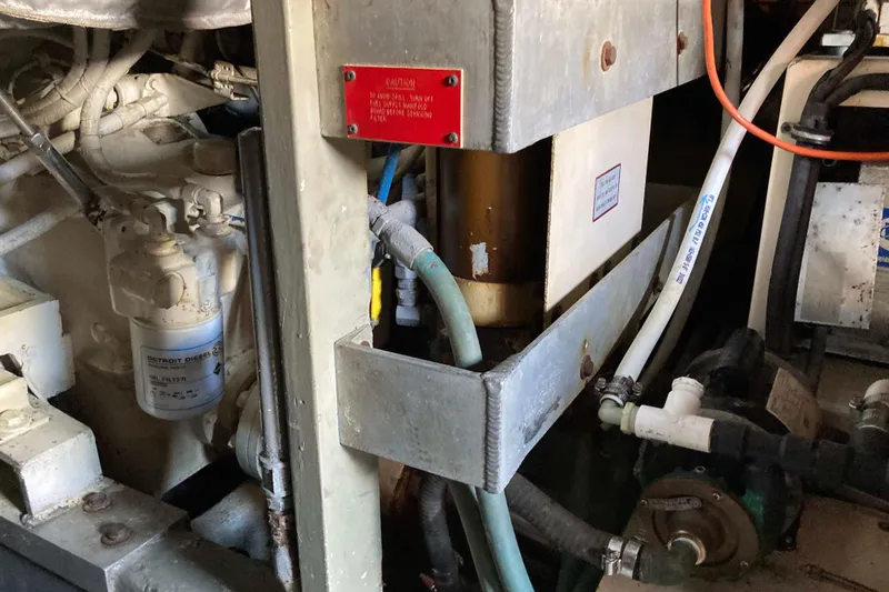 Golden Olive Yacht Photos Pics Engine room of 1985 Hatteras Sportfish boat showing oil filter and mechanical components.