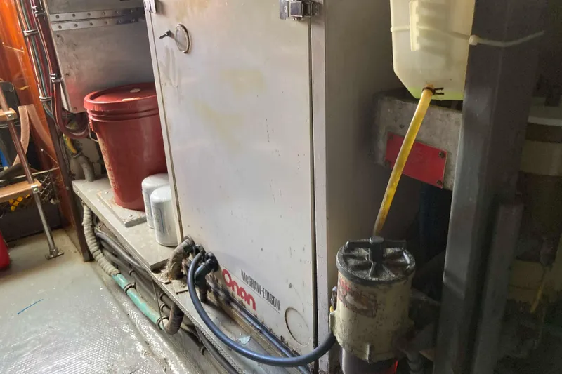 Golden Olive Yacht Photos Pics Engine room of 1985 Hatteras Sportfish with generator and maintenance equipment.