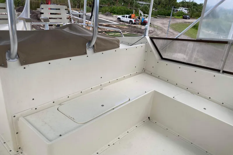 Golden Olive Yacht Photos Pics 1985 Hatteras Sportfish boat interior with white seating and outdoor view.