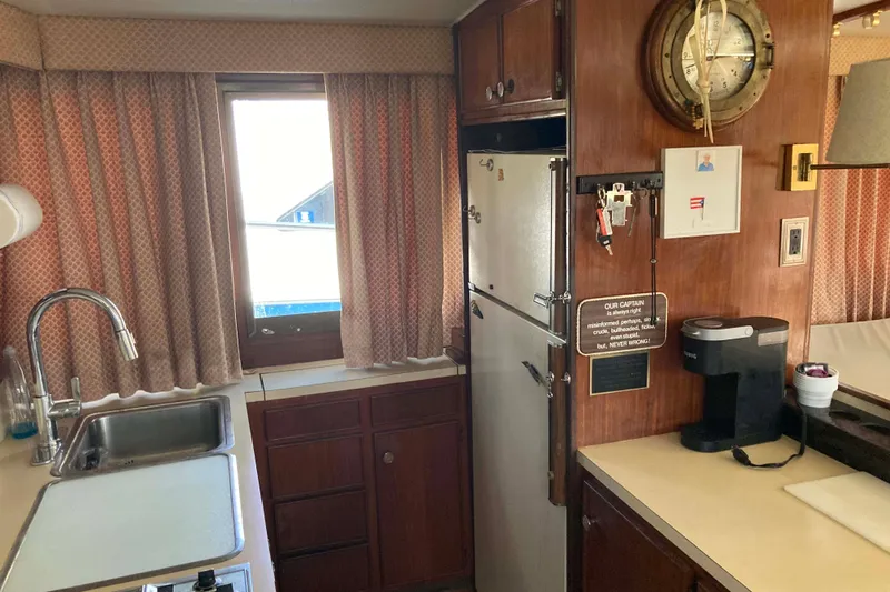 Golden Olive Yacht Photos Pics 1985 Hatteras Sportfish kitchen interior with sink, fridge, and coffee maker.