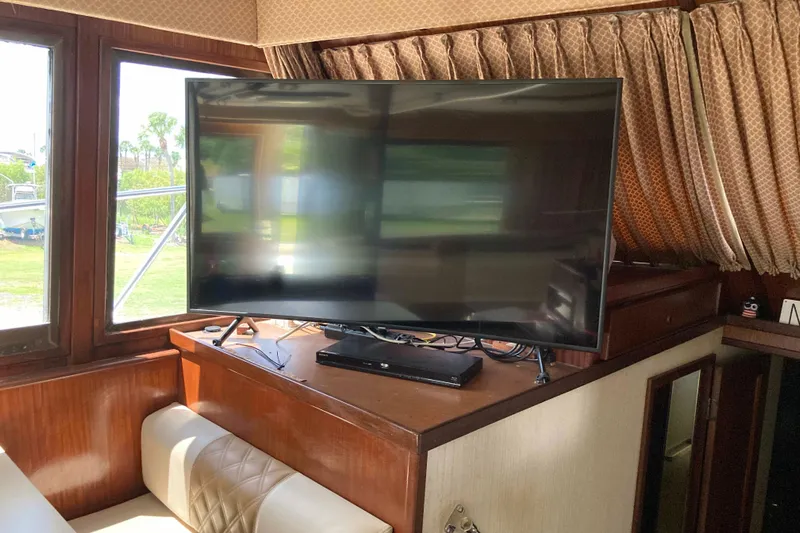 Golden Olive Yacht Photos Pics Interior of 1985 Hatteras Sportfish with TV and wood paneling.