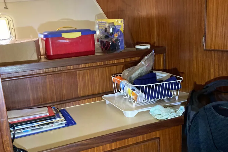 Golden Olive Yacht Photos Pics Interior of 1985 Hatteras Sportfish with storage shelves and various items.