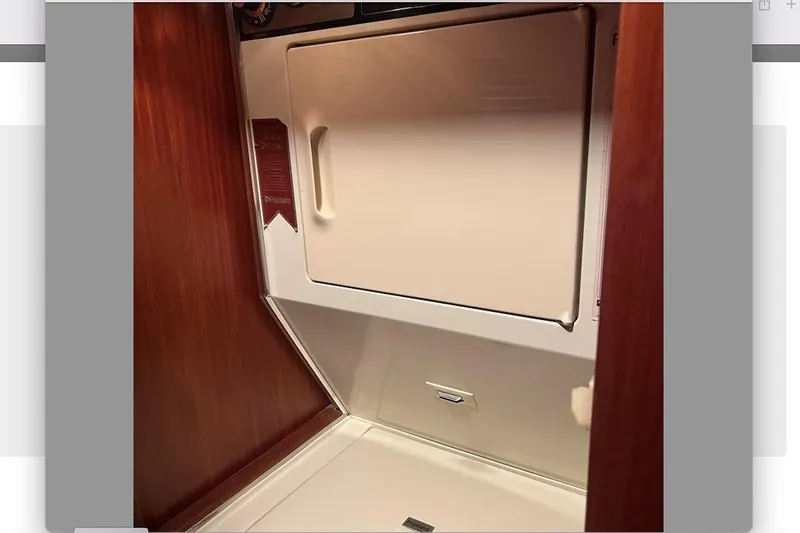 Golden Olive Yacht Photos Pics 1985 Hatteras Sportfish interior with wooden paneling and built-in storage compartment.