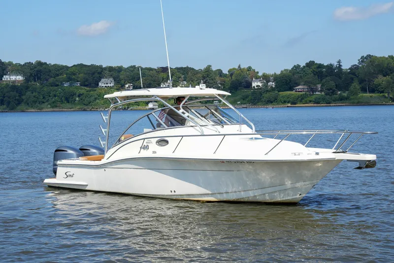  Yacht Photos Pics 2008 Scout 295 Abaco boat on calm water with scenic background.