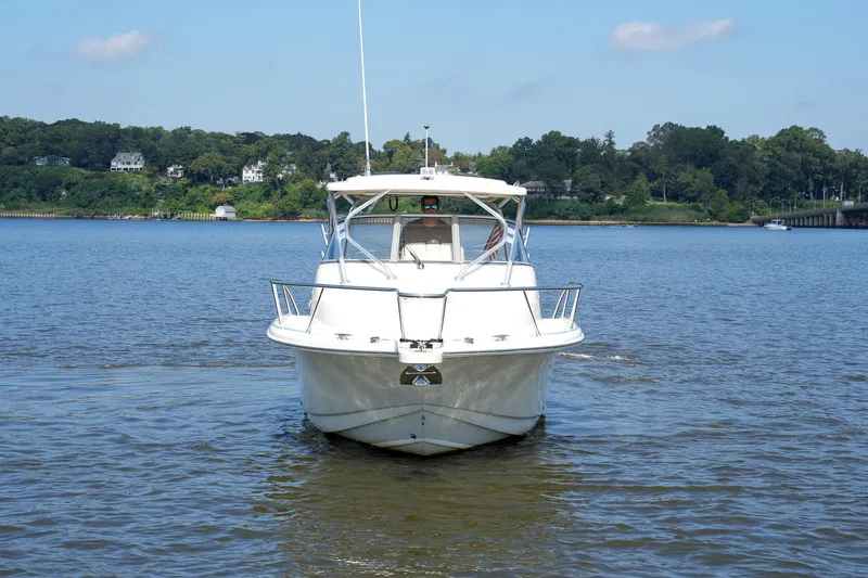  Yacht Photos Pics 2008 Scout 295 Abaco boat cruising on a calm river with scenic background.