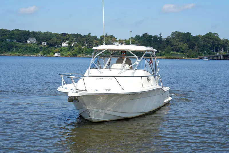  Yacht Photos Pics 2008 Scout 295 Abaco boat cruising on a calm river with scenic background.