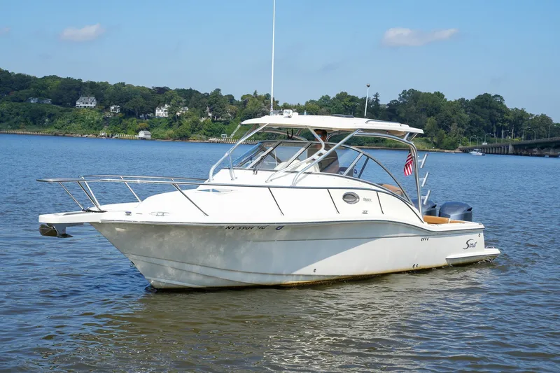  Yacht Photos Pics 2008 Scout 295 Abaco boat on calm water with scenic background.
