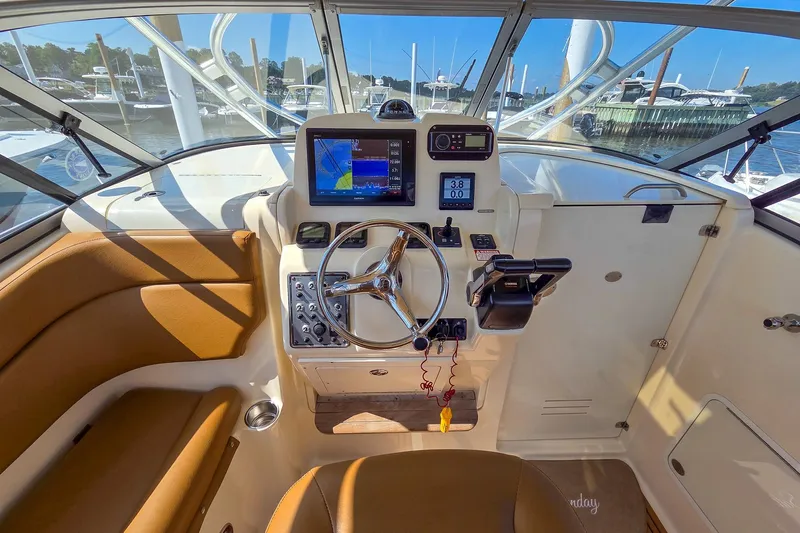  Yacht Photos Pics 2008 Scout 295 Abaco boat helm with navigation system and steering wheel.