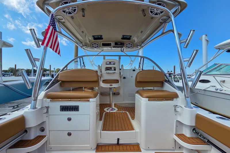  Yacht Photos Pics 2008 Scout 295 Abaco boat interior with seating, rod holders, and American flag.