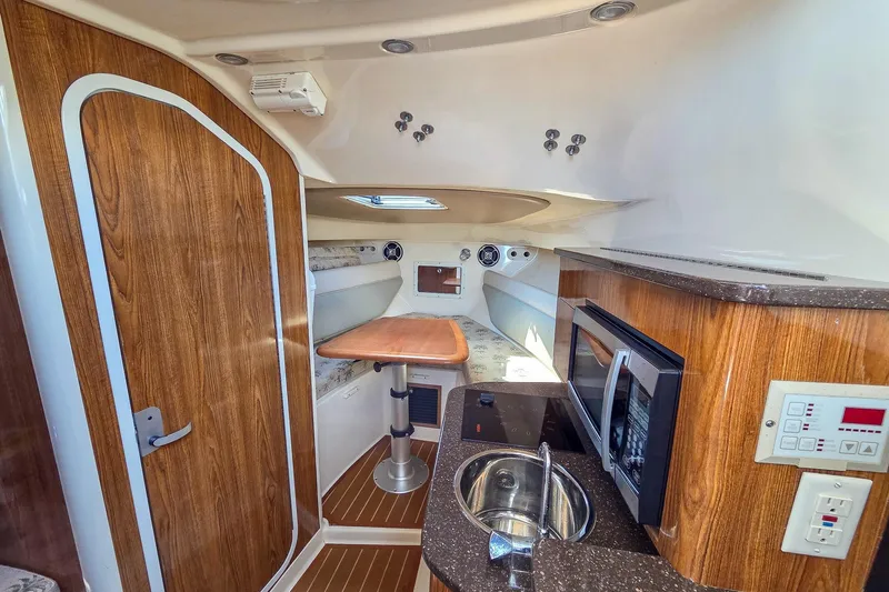  Yacht Photos Pics Interior of 2008 Scout 295 Abaco boat with kitchenette and wooden finishes.