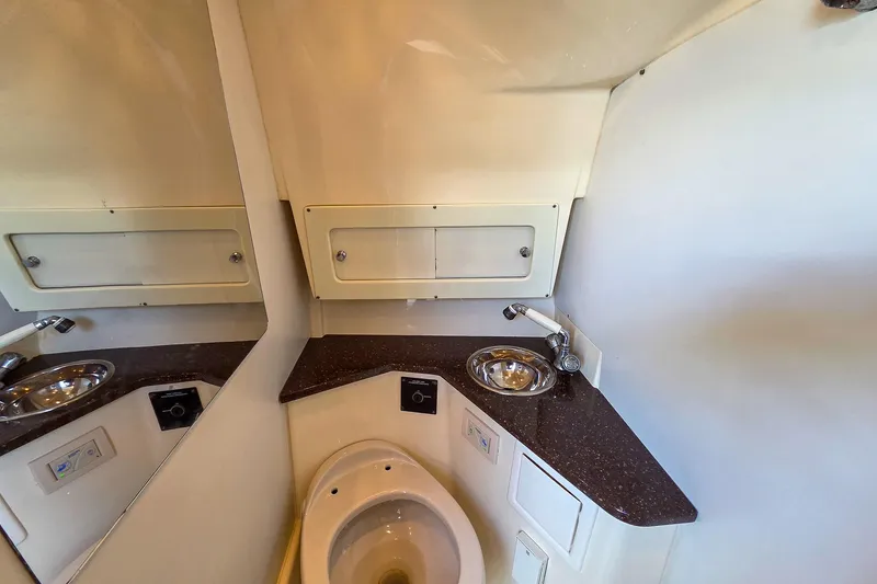  Yacht Photos Pics 2008 Scout 295 Abaco boat bathroom with sink, toilet, and storage cabinets.
