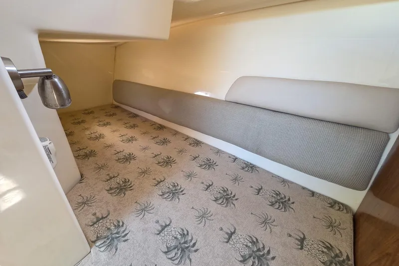  Yacht Photos Pics 2008 Scout 295 Abaco cabin interior with pineapple-patterned carpet and cushioned seating.