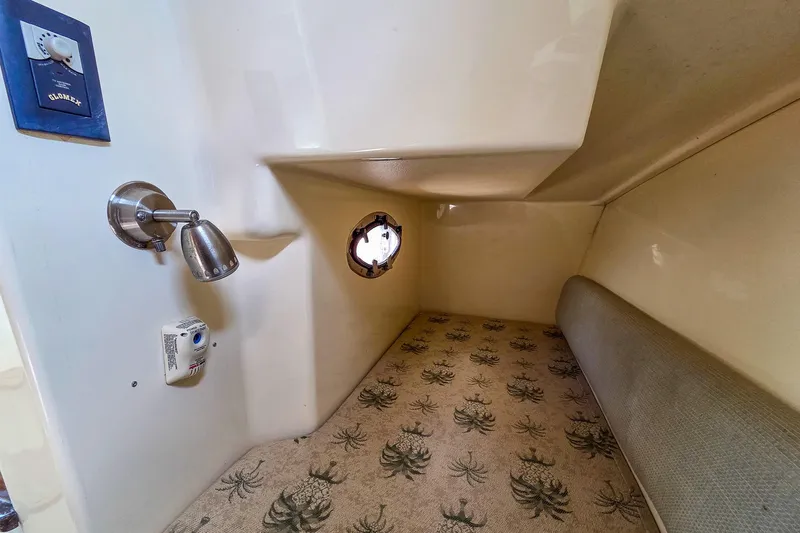  Yacht Photos Pics 2008 Scout 295 Abaco cabin interior with patterned flooring and wall-mounted light.