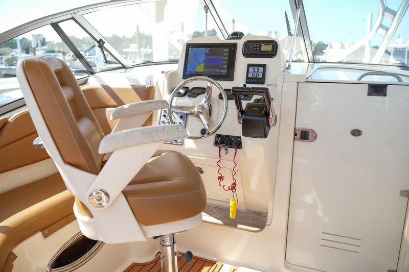  Yacht Photos Pics Helm of 2008 Scout 295 Abaco boat with steering wheel and navigation equipment.