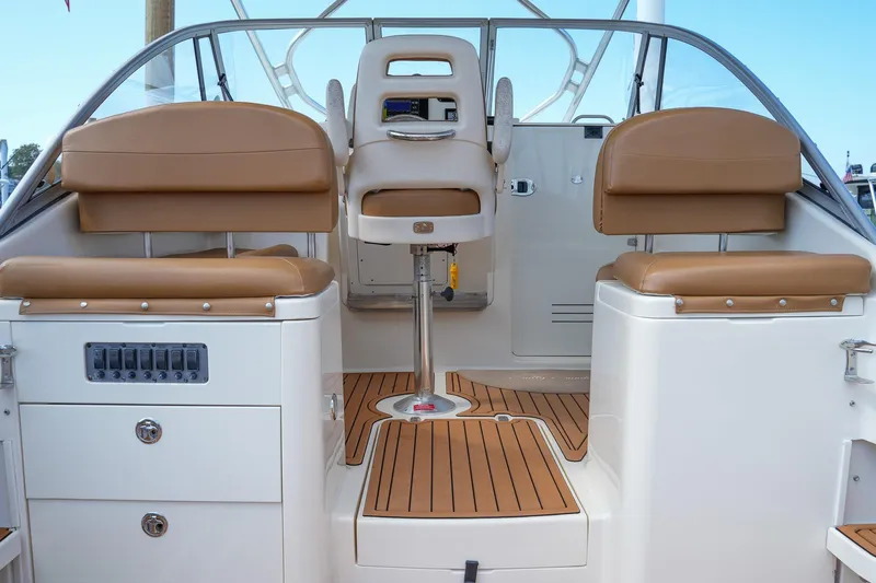  Yacht Photos Pics 2008 Scout 295 Abaco boat interior with tan seating and wood flooring.