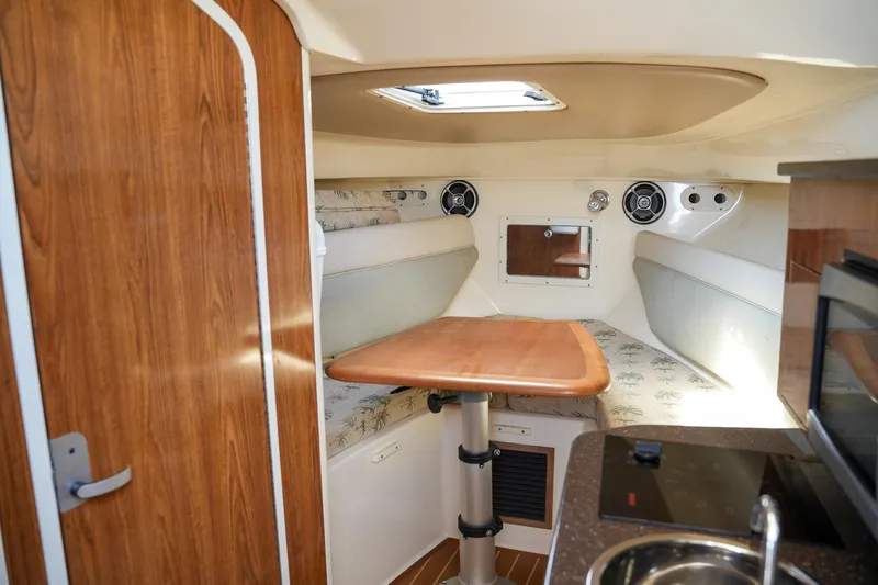  Yacht Photos Pics 2008 Scout 295 Abaco cabin interior with wood accents and compact dining area.