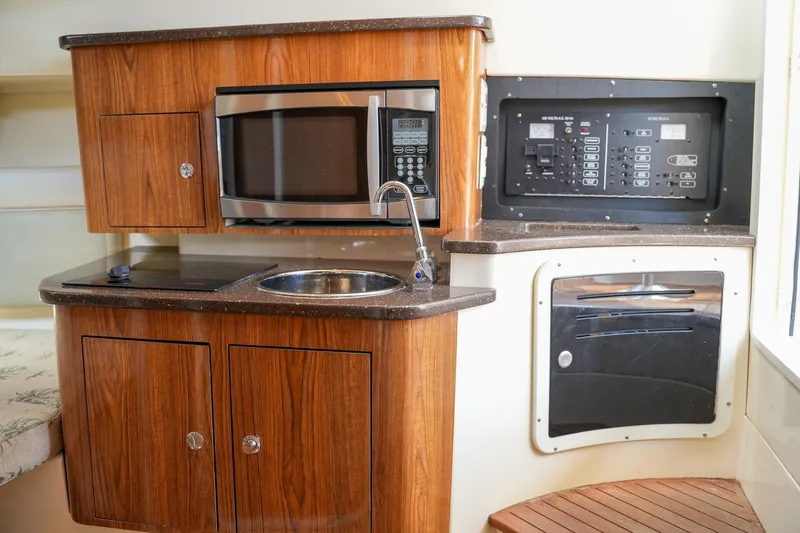  Yacht Photos Pics 2008 Scout 295 Abaco boat interior with kitchenette, microwave, sink, and control panel.
