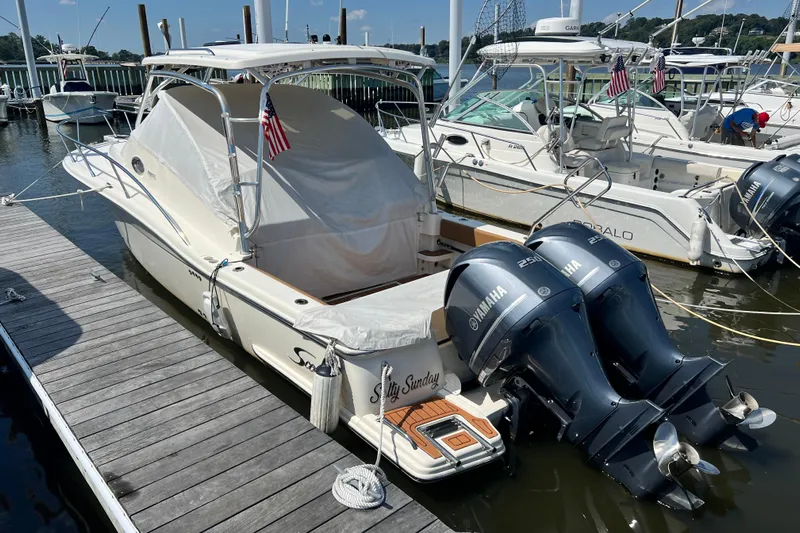  Yacht Photos Pics 2008 Scout 295 Abaco boat docked with twin Yamaha engines, covered deck, and American flag.