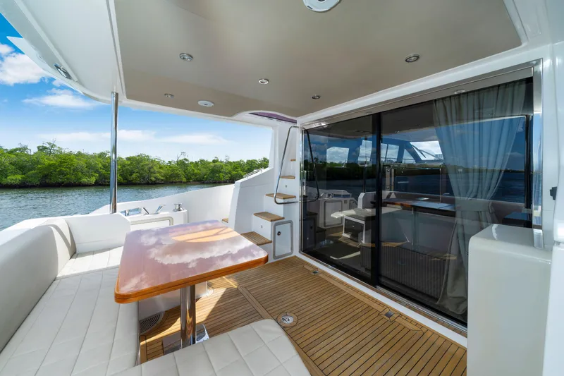 Our Trade Yacht Photos Pics Luxurious 2018 Azimut 50 Fly yacht with elegant outdoor seating and scenic water view.